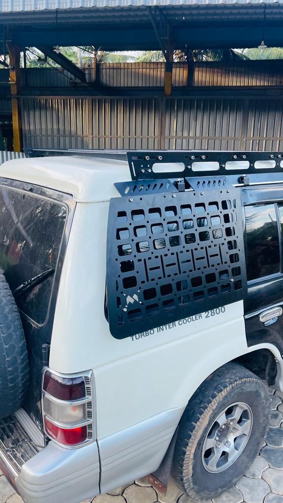 Laser-cut MOLLE window panel and roof rack on an SUV