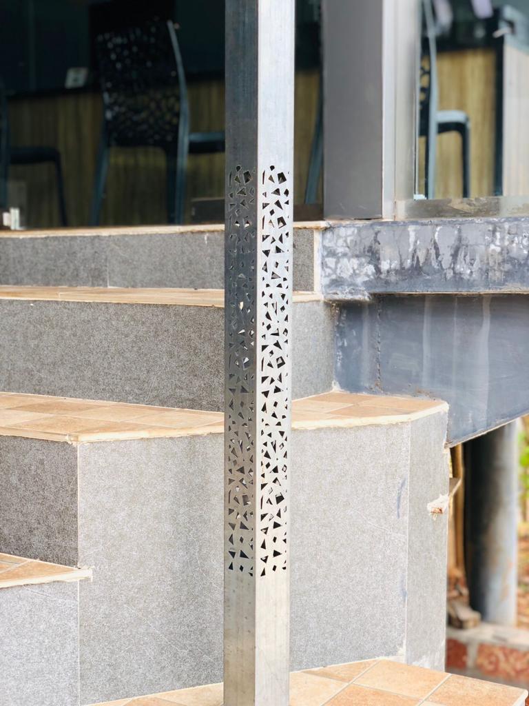 Perforated column cladding on a staircase